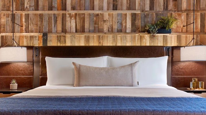 The reclaimed-timber headboard, hand-finished