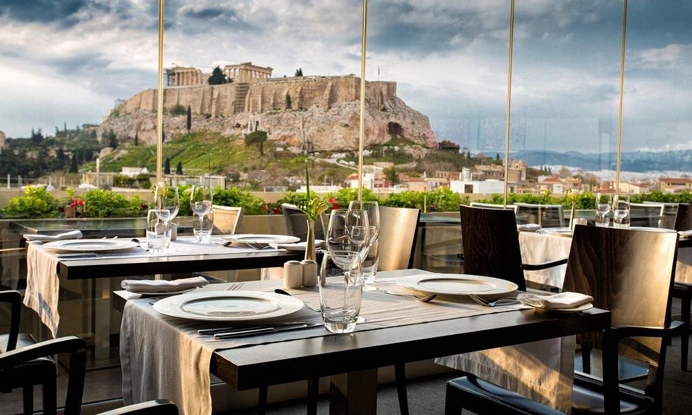 The rooftop restaurant at The Athens Gate Hotel beneath a dramatic sky