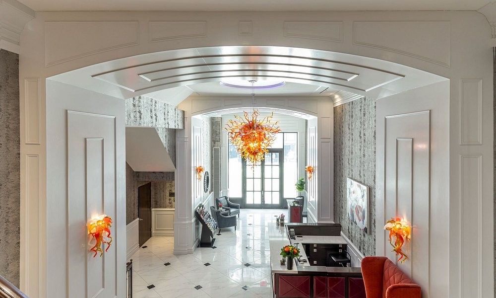 The lobby at Broadway Plaza Hotel, beneath an archway and hand-blown glass chandelier