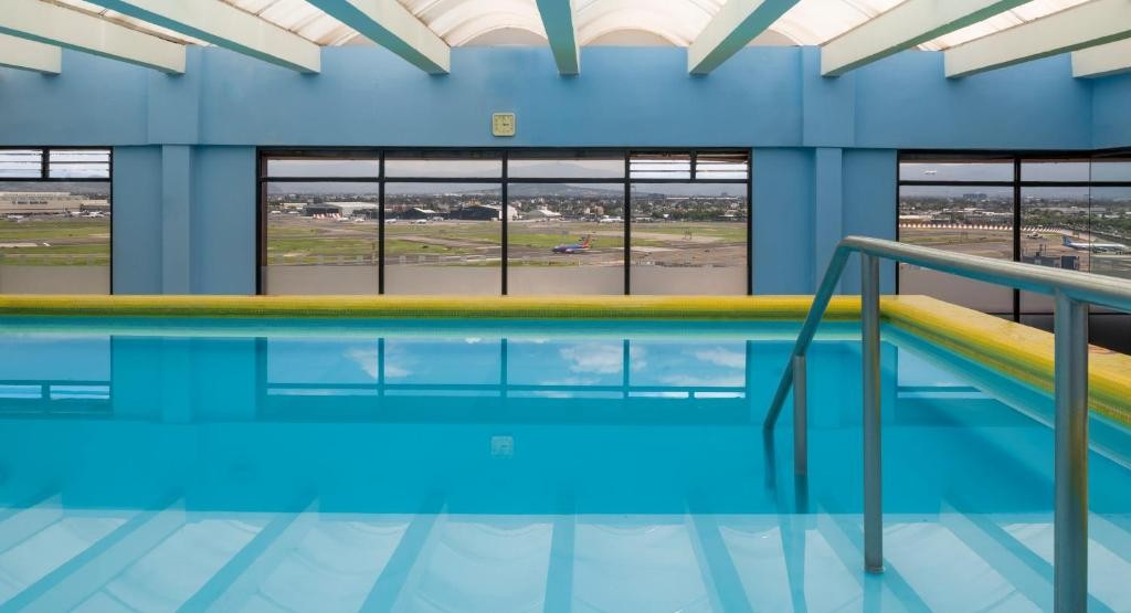 The airport runway, seen through the windows of Camino Real Aeropuerto's pool