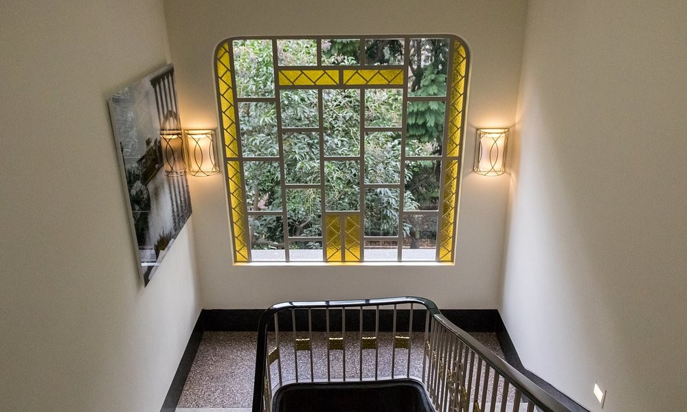 An Art Deco stained-glass window above the staircase at Casa Malí by Dominion