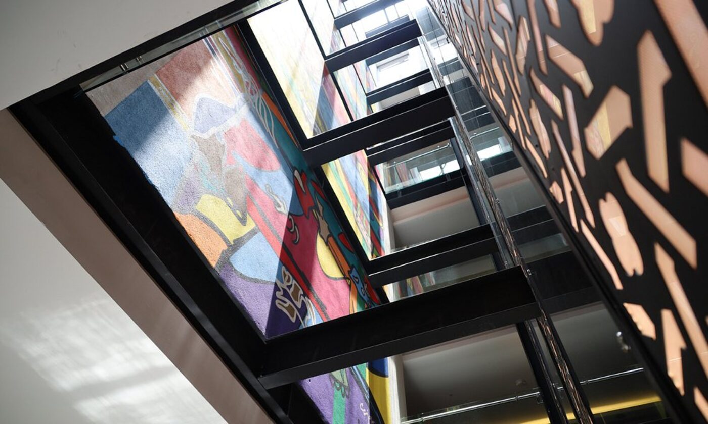 Looking up through the hotel's central atrium, past a colourful mural