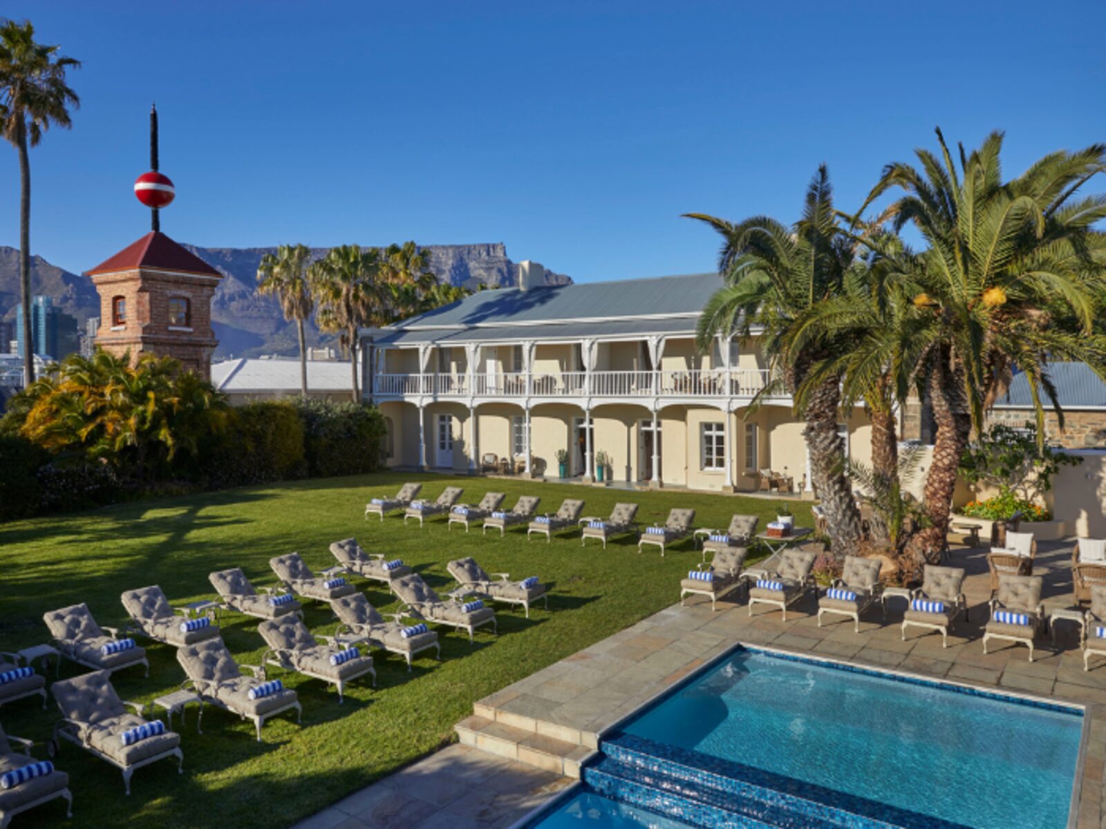 The hotel's lawn and pool, with Table Mountain and the historic Time Ball Tower beyond