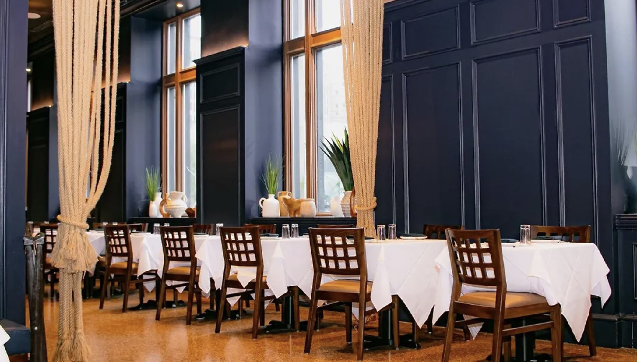 The dining room at The Empire Hotel, with tall windows and dark wood panelling