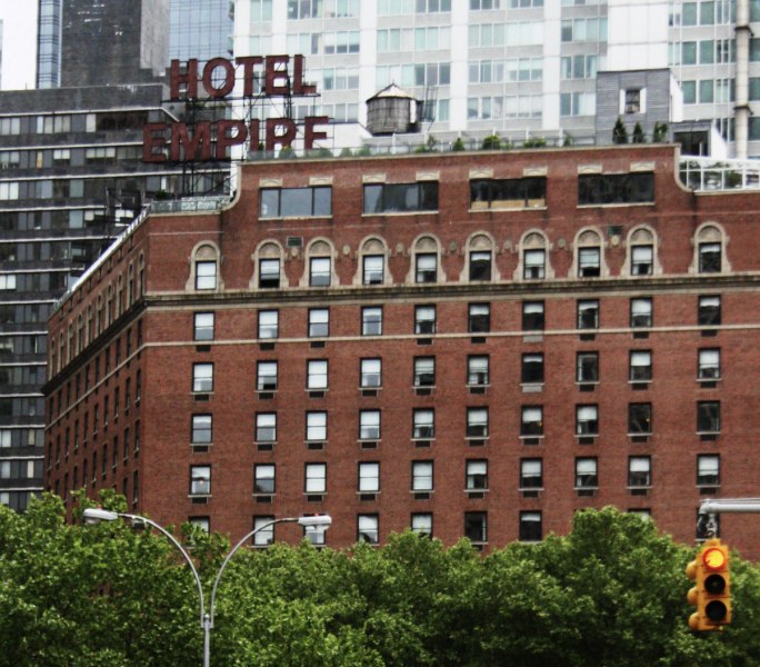 The Empire Hotel's red-brick facade and rooftop signage on Broadway