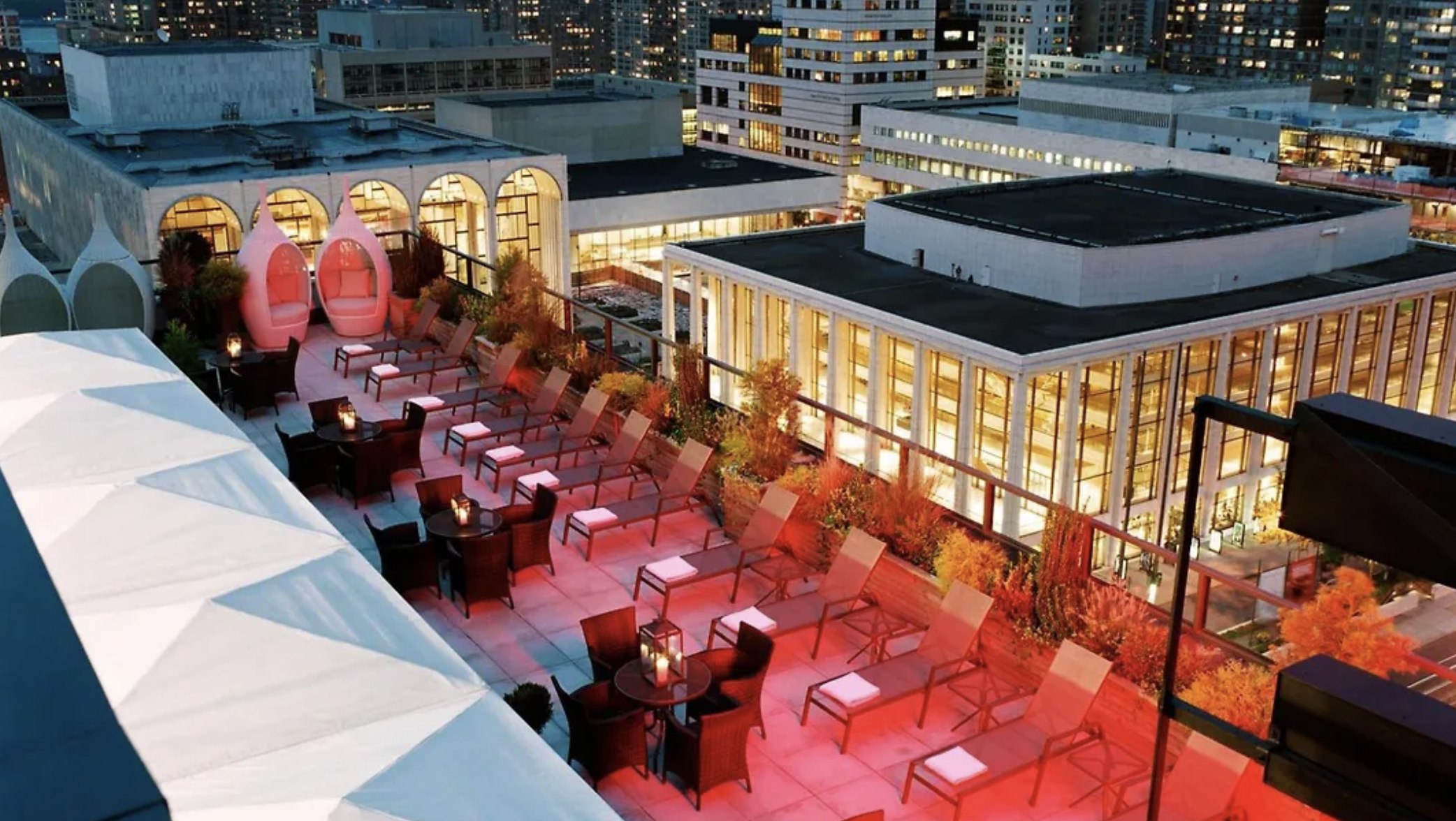 The Empire Hotel's rooftop terrace looking out over Lincoln Center, lit up at night