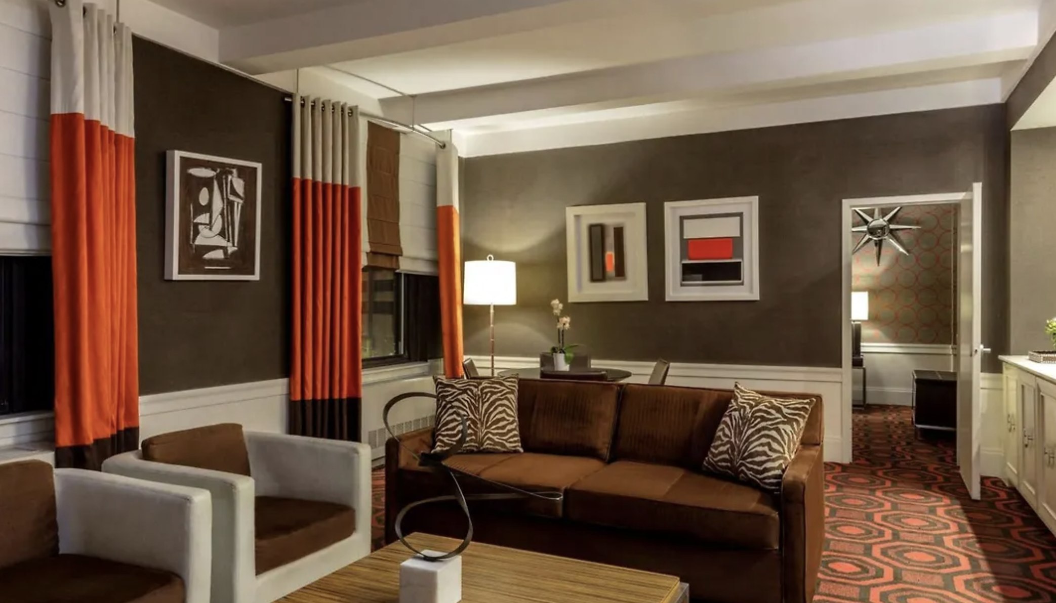 A suite living room at The Empire Hotel, with warm woods and tailored textiles