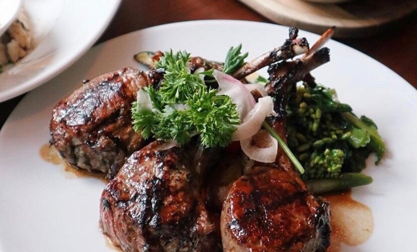 Grilled lamb chops plated at the hotel restaurant