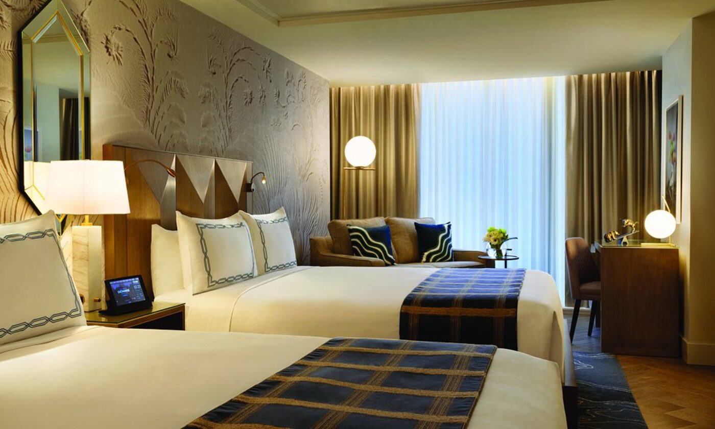 A double room with patterned wallpaper and gold accents