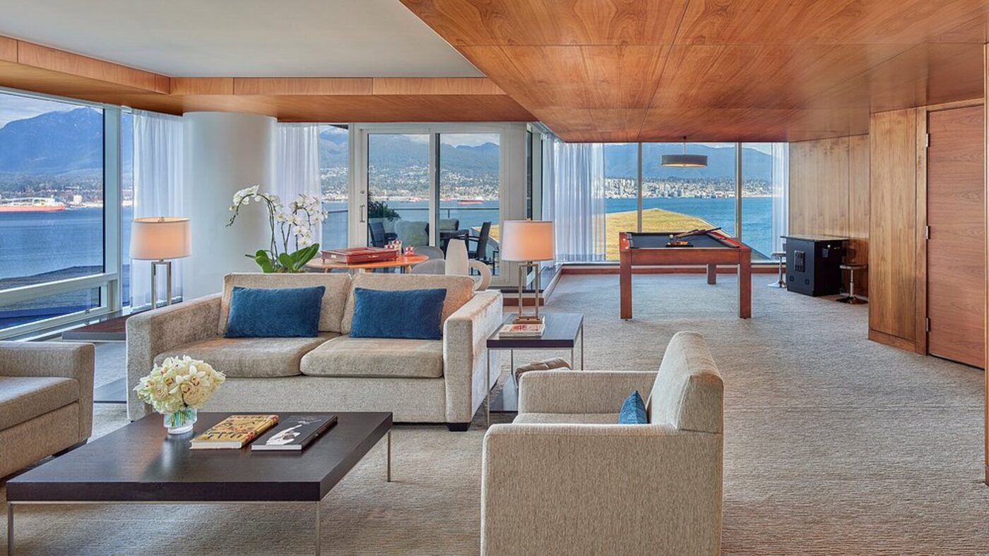 A suite living room with a pool table and harbour views