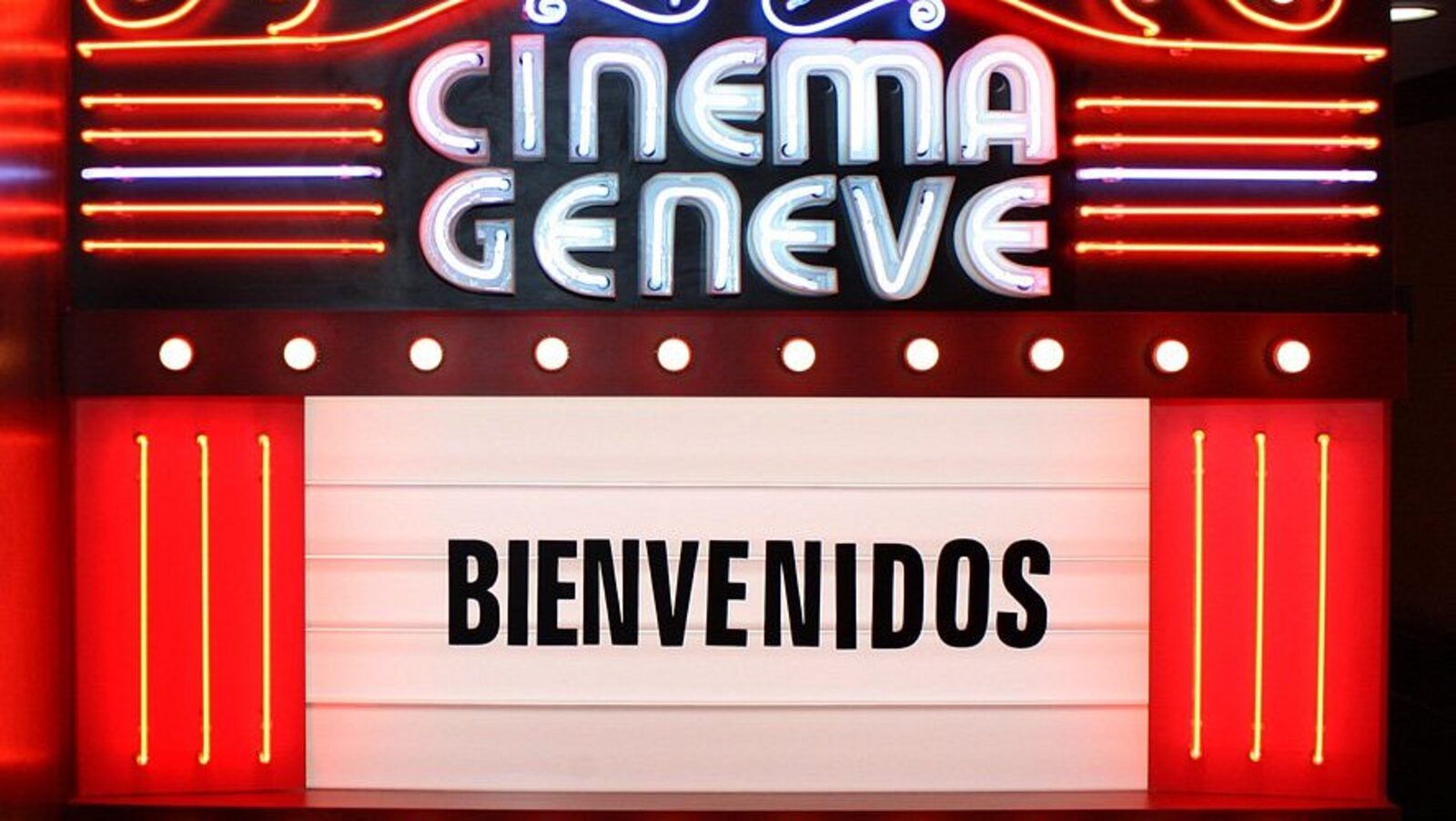 The neon marquee of the hotel's Cinema Geneve, reading Bienvenidos