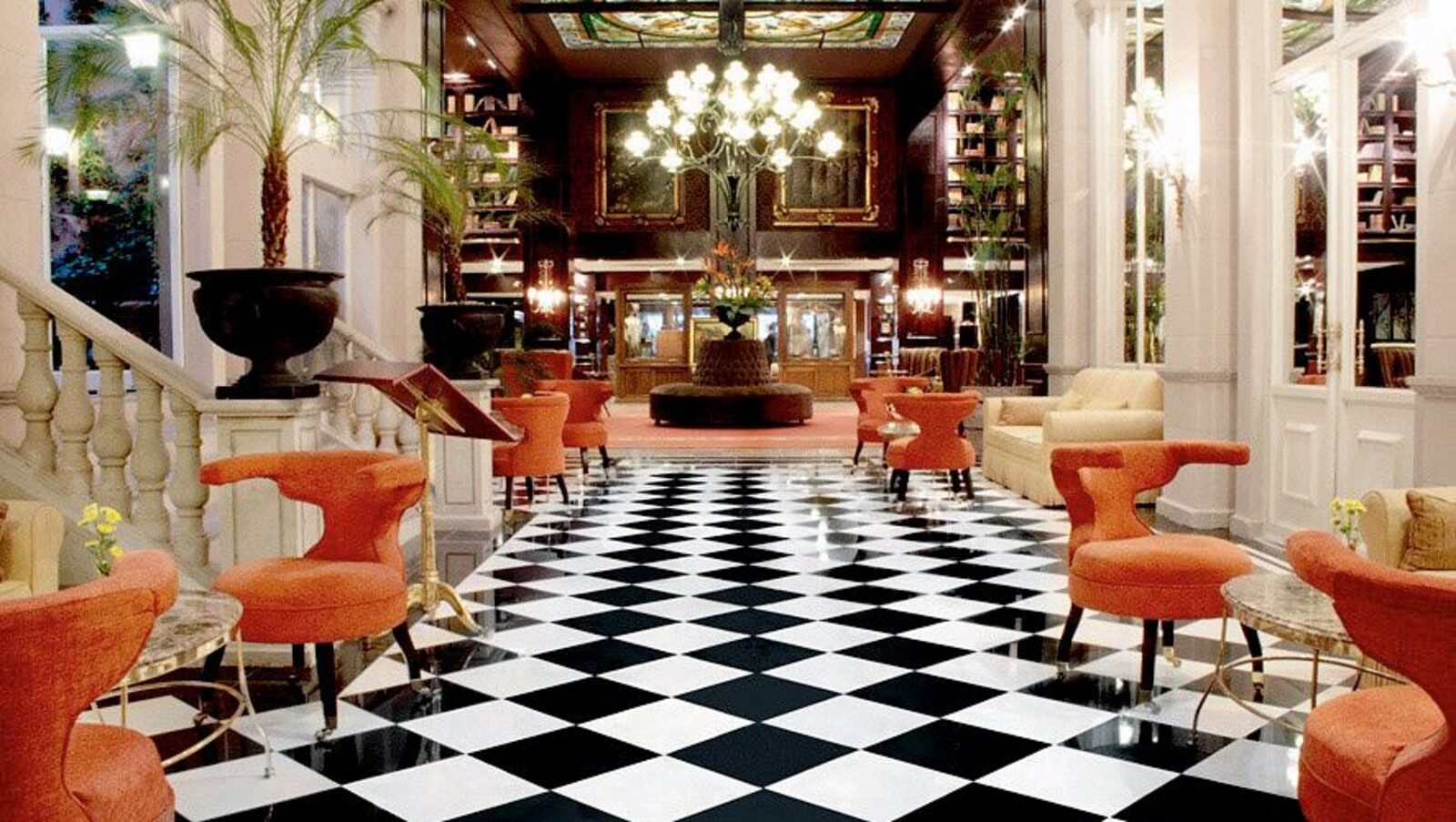The hotel's grand lobby, with a checkerboard floor and orange chairs, steps from the Zona Rosa streets