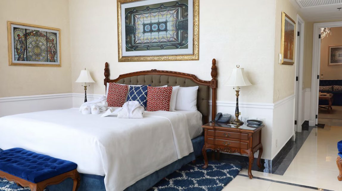 A guest room hung with stained-glass-inspired artwork