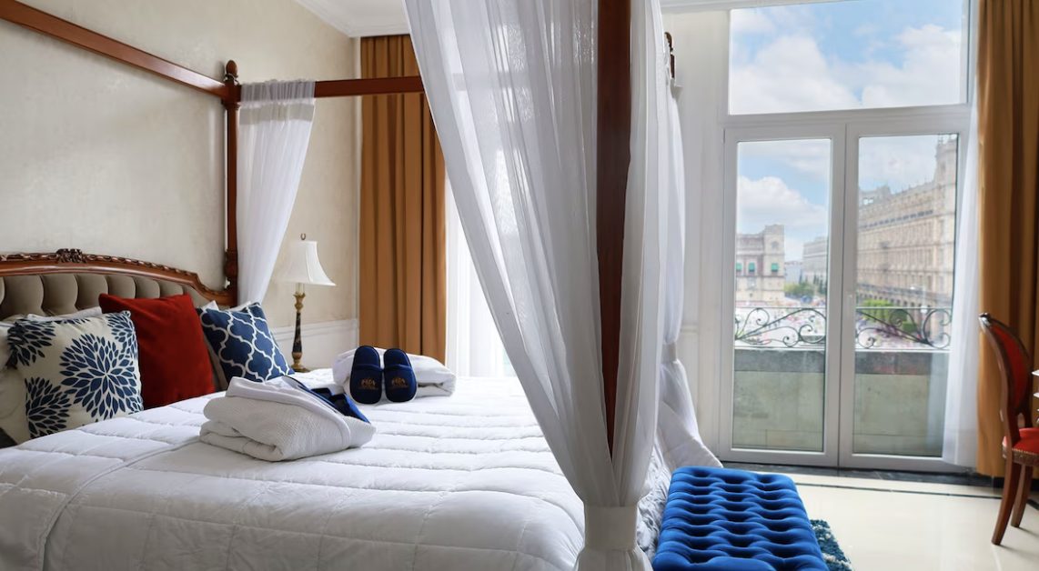 A canopied room dressed in blue and white