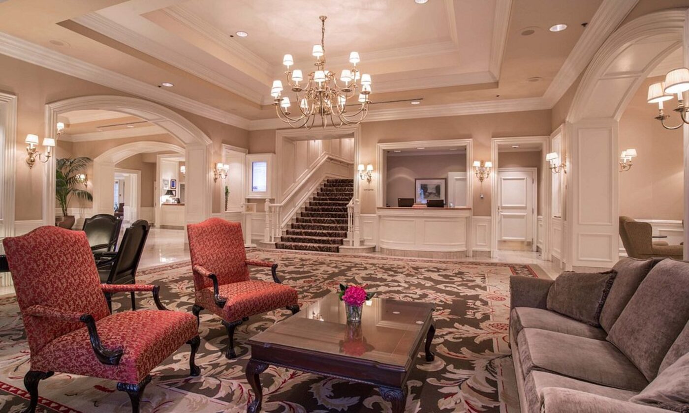 The Sutton Place Hotel's grand lobby, with a chandelier and staircase