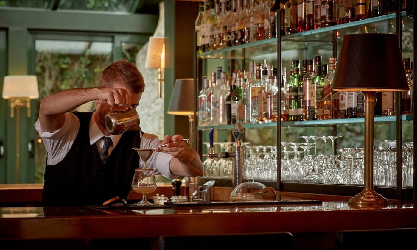 A bartender preparing a cocktail at the hotel bar