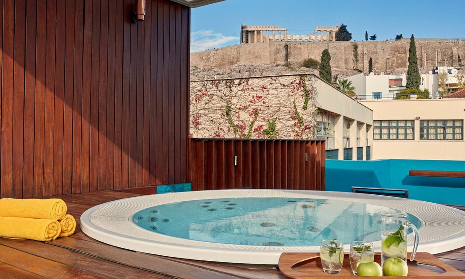A rooftop hot tub with the Acropolis rising just beyond the hotel