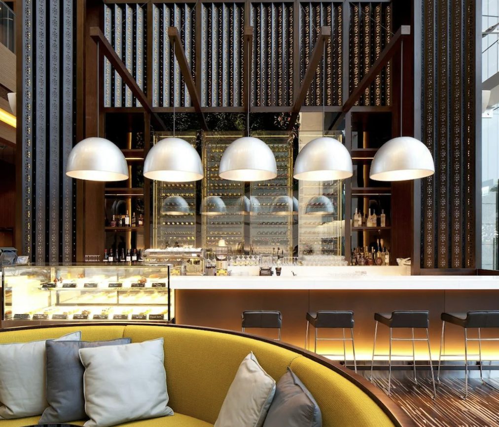 The bar and patisserie counter beneath dome pendants