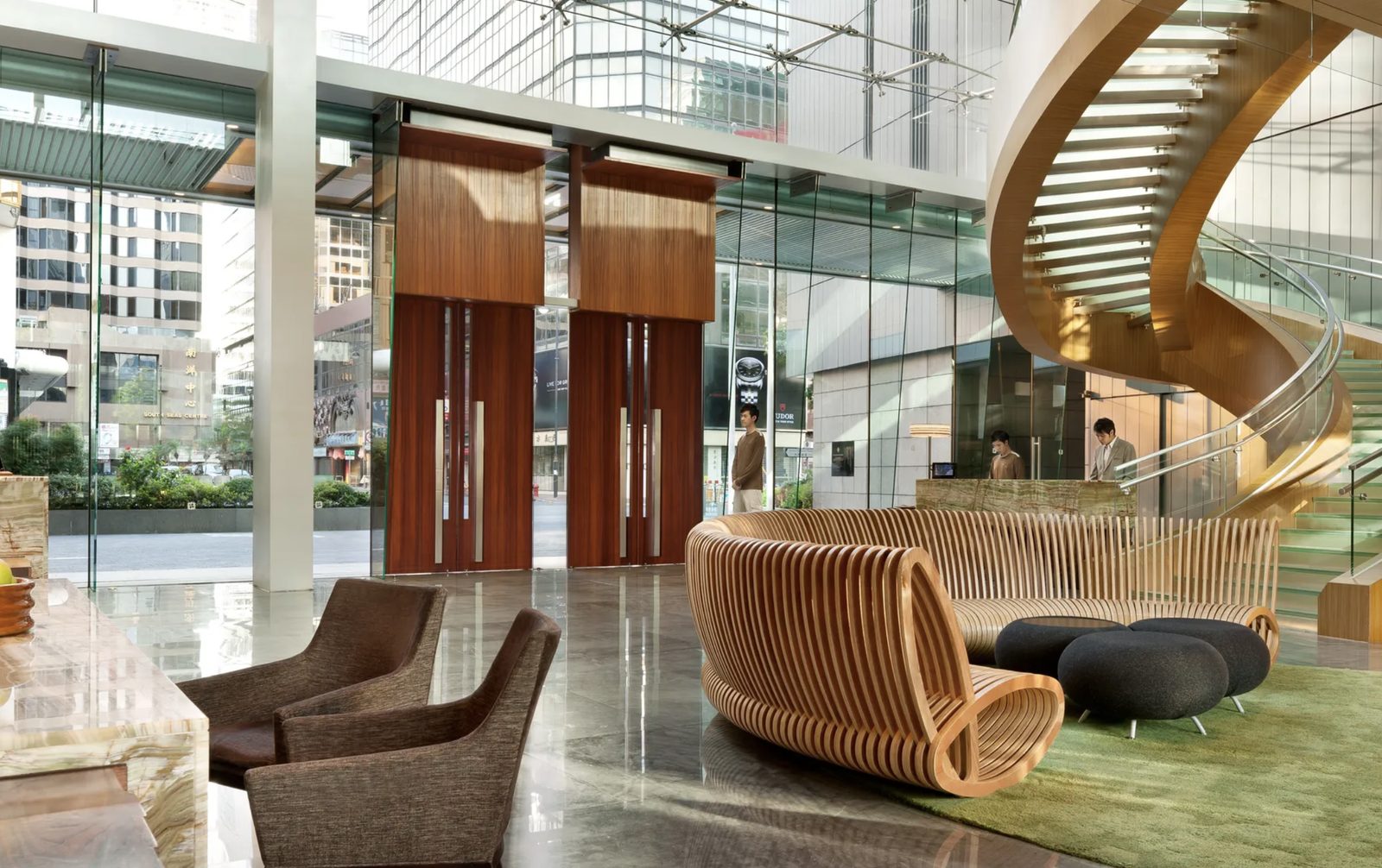 The sculptural spiral staircase and coiled timber bench in the lobby