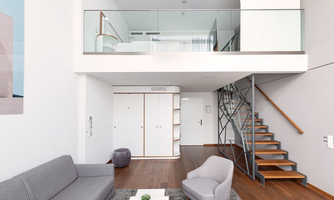 A duplex suite at MOA Berlin with a mezzanine and open staircase