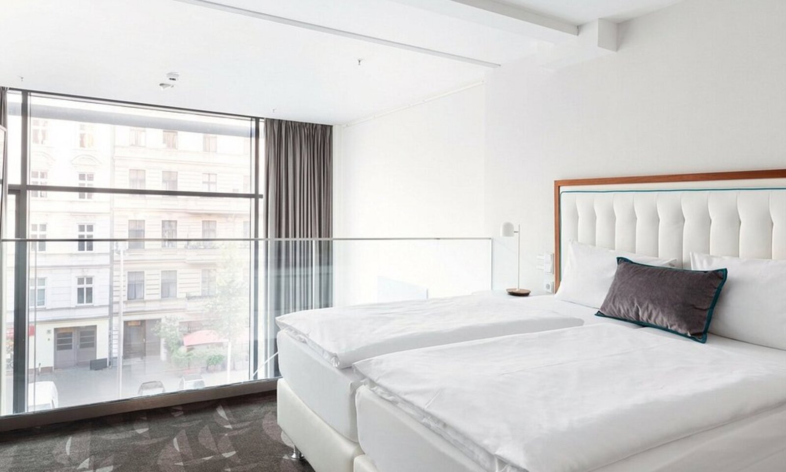 A calm, contemporary room at MOA Berlin with a large window over the street