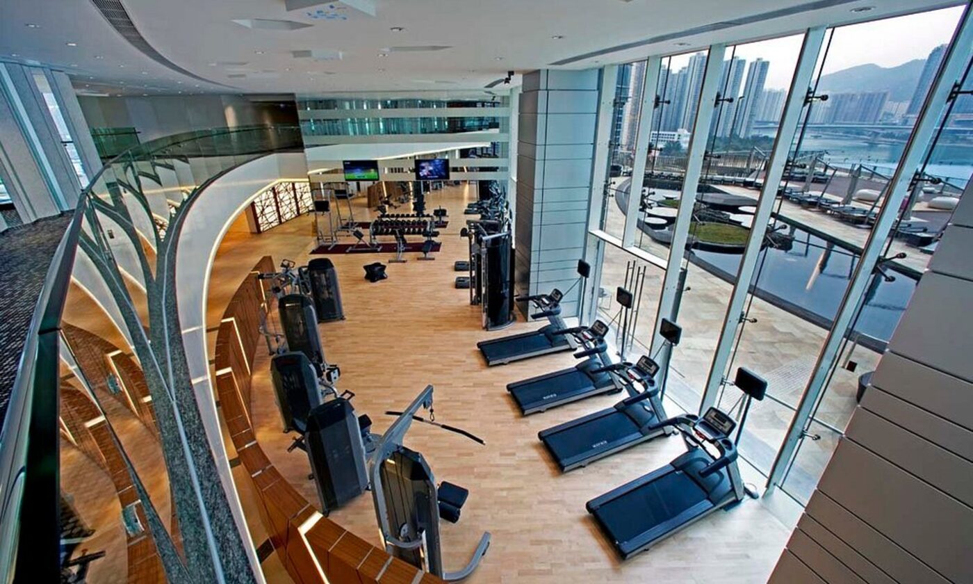 The hotel's fitness centre overlooking the pool deck and skyline