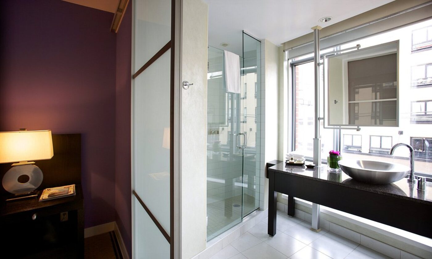 A bathroom with bold purple walls