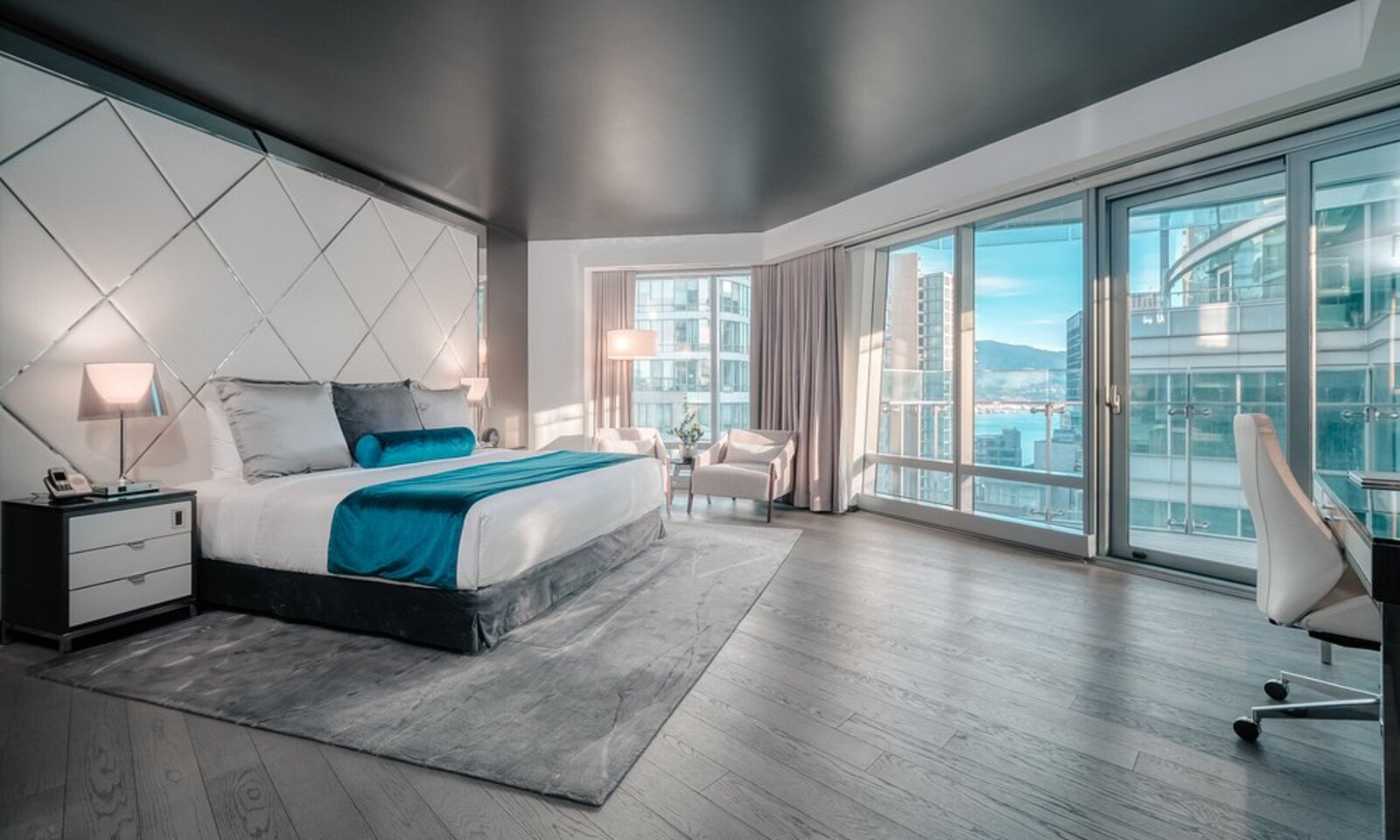 A desk by a floor-to-ceiling window overlooking a city skyline