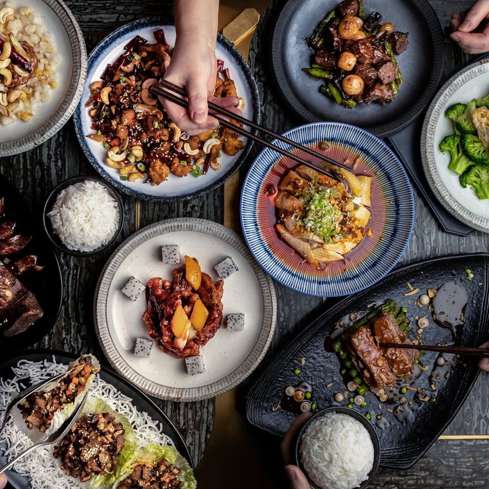 A shared table of dishes at one of Paradox Hotel Vancouver's restaurants