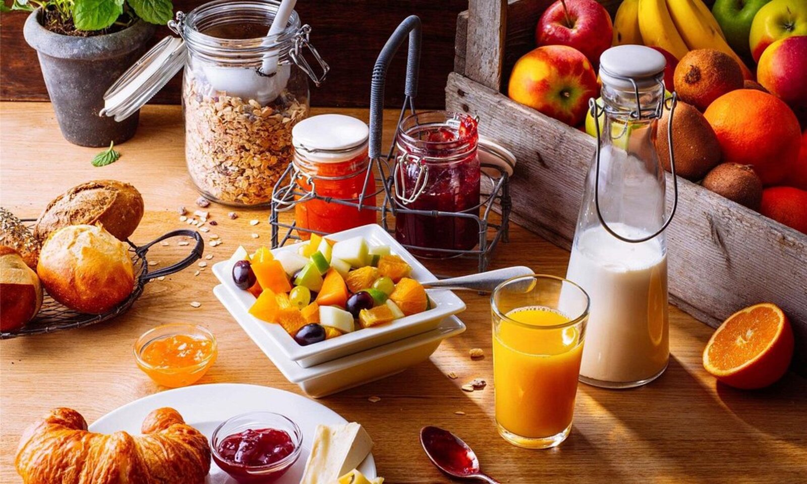 Breakfast spread of fresh fruit, pastries and juice