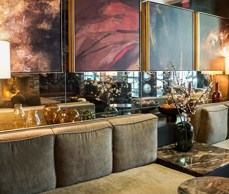 The Loden Hotel's lobby lounge, with mirrored walls and abstract art