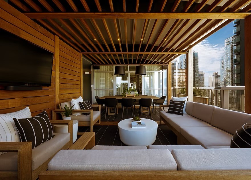 A wood-slatted rooftop terrace at the Loden Hotel, overlooking the city