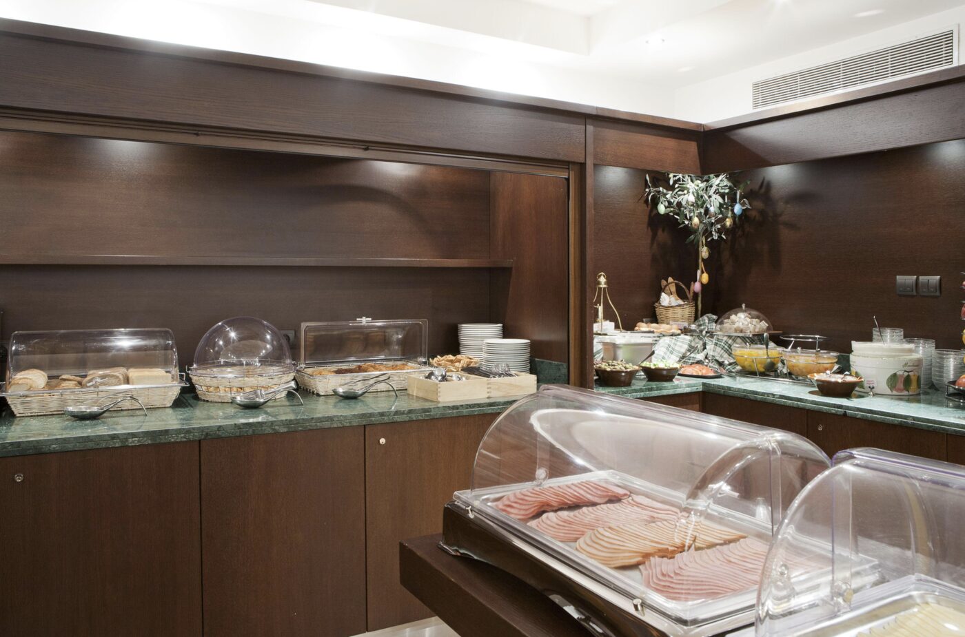 A buffet spread of breads, cold cuts and dishes at Plaka Hotel's breakfast room