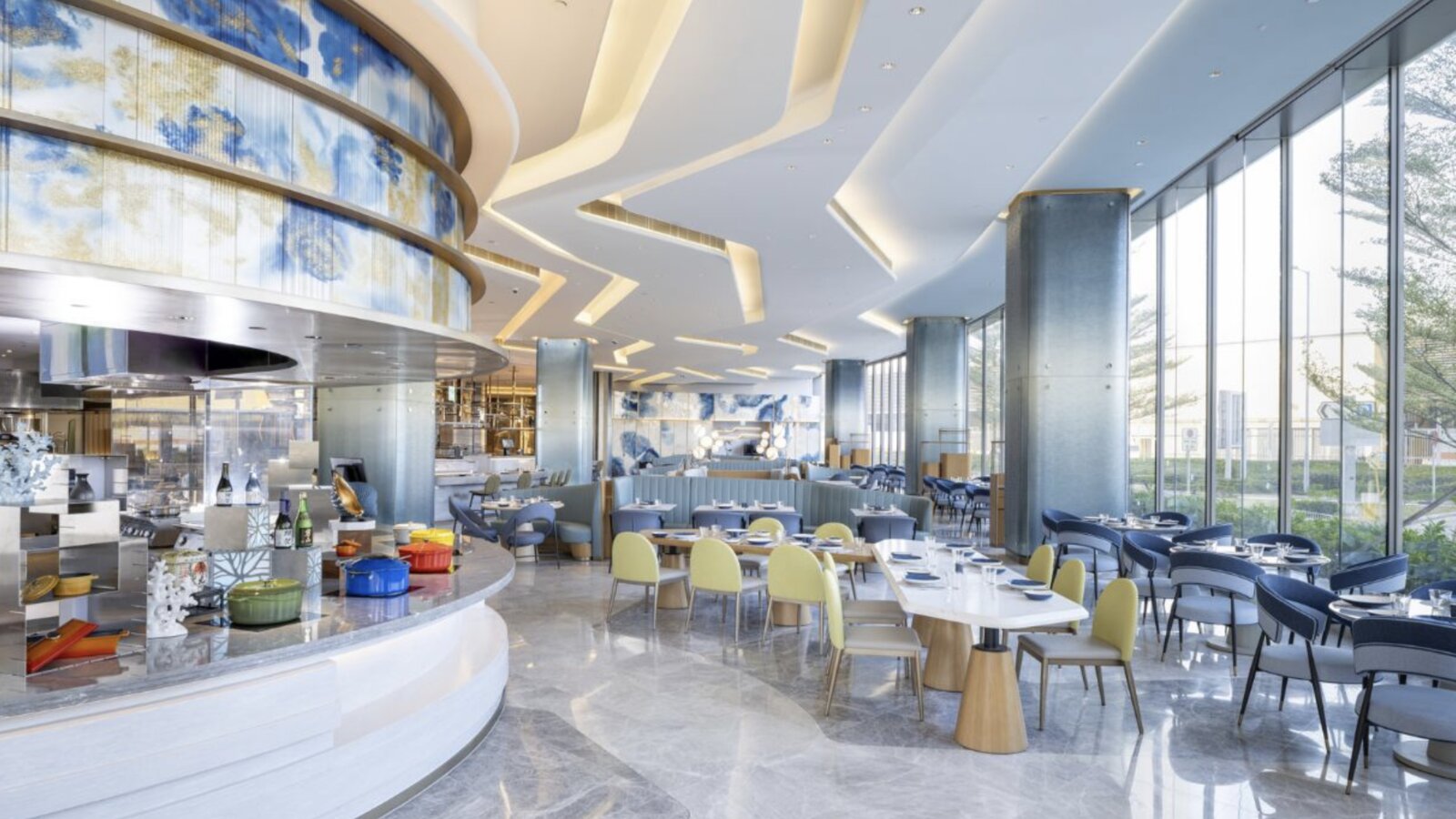 A bright, open-kitchen restaurant at Regala Skycity Hotel with blue and gold decor