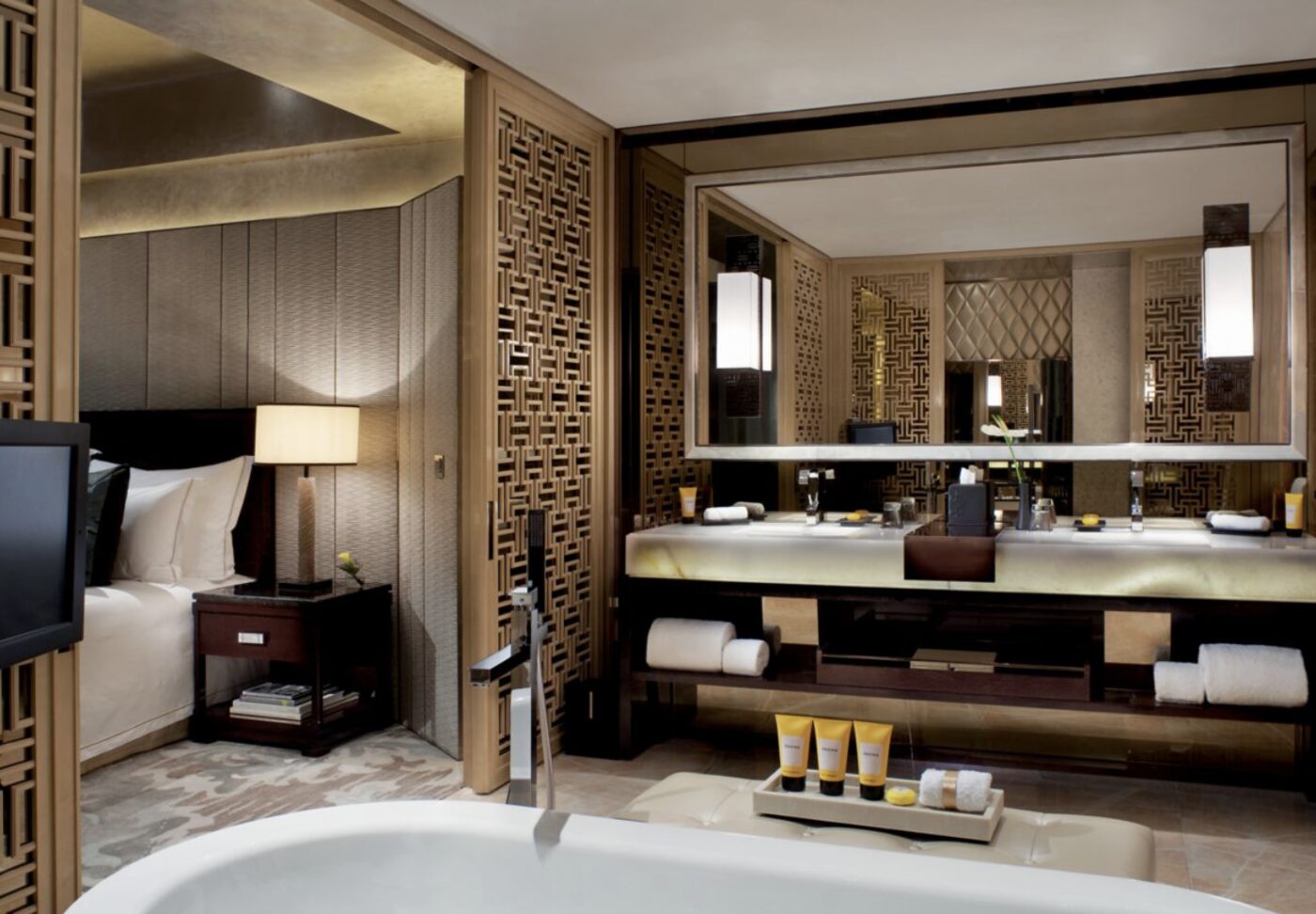 A marble bathroom opening onto the bedroom in a suite at The Ritz-Carlton, Hong Kong