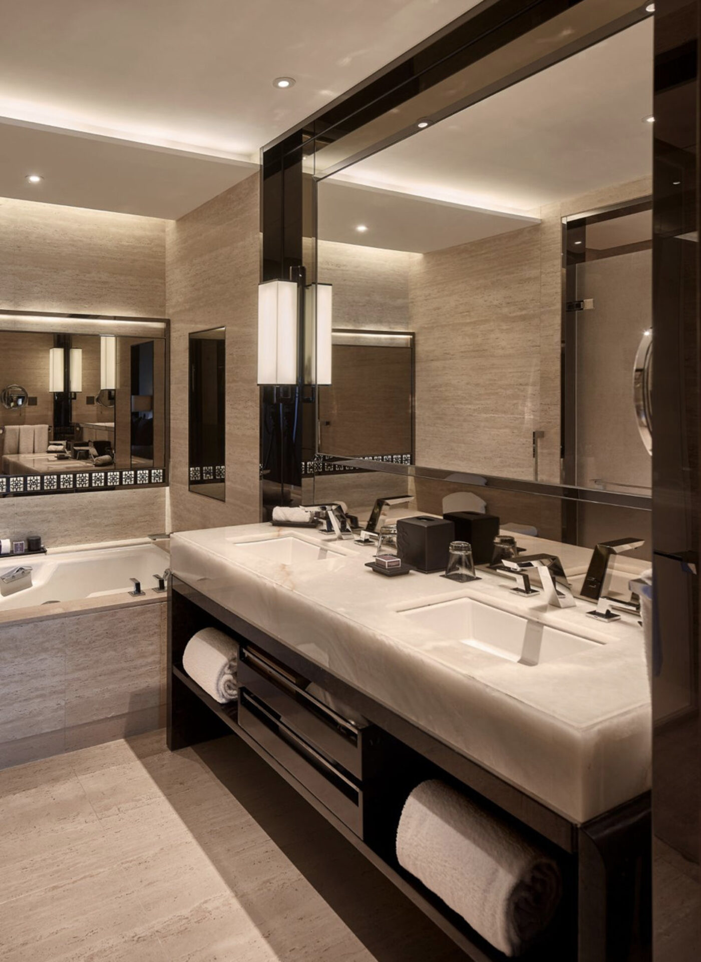 A double vanity bathroom at The Ritz-Carlton, Hong Kong with a soaking tub beyond