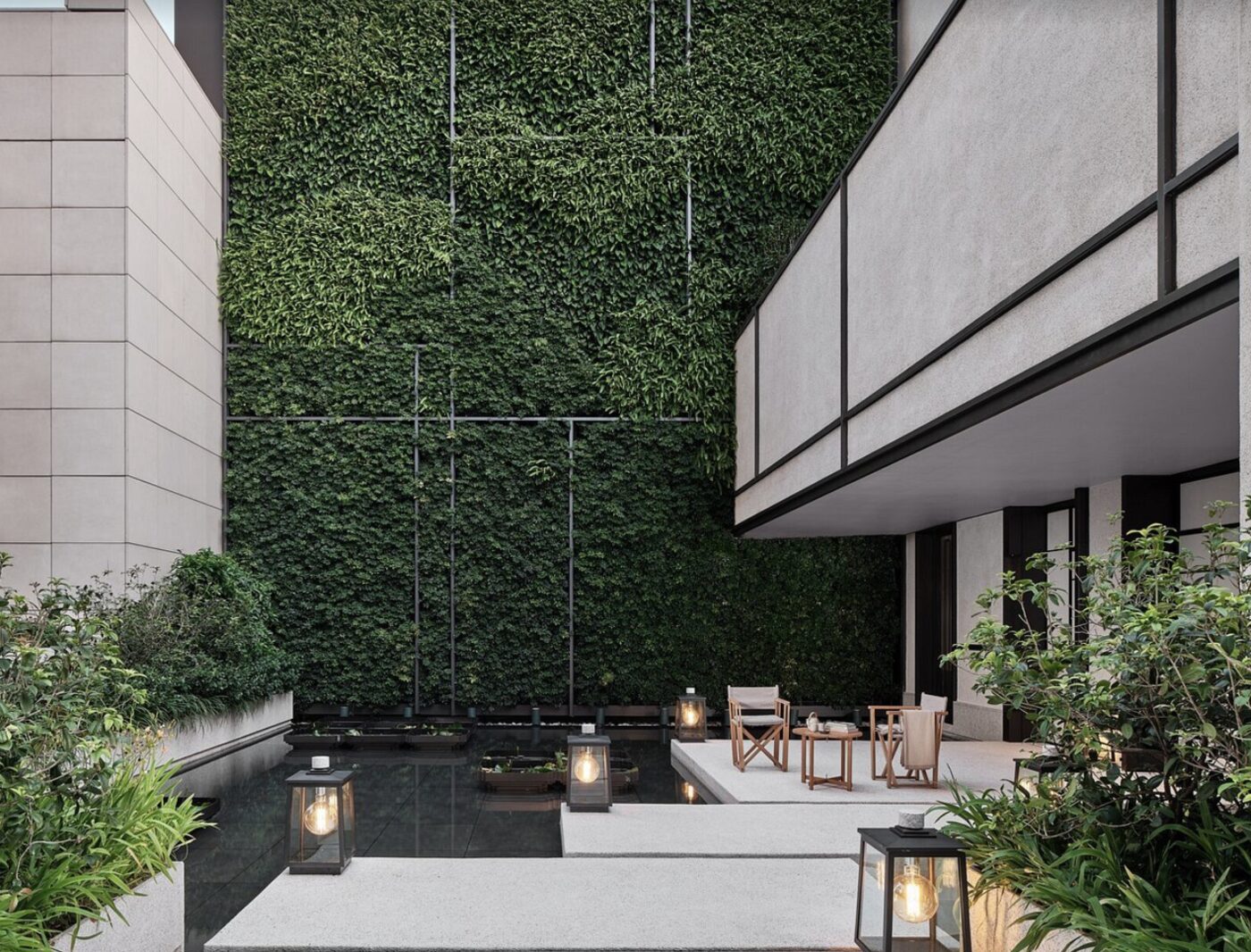 A quiet courtyard at Rosewood Hong Kong with a living green wall and lantern-lit seating
