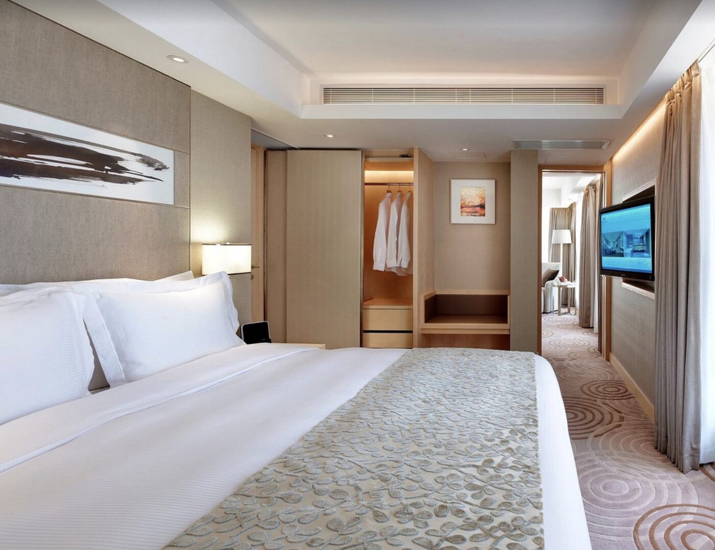 A bedroom at The Royal Garden with a walk-in closet and dressing nook