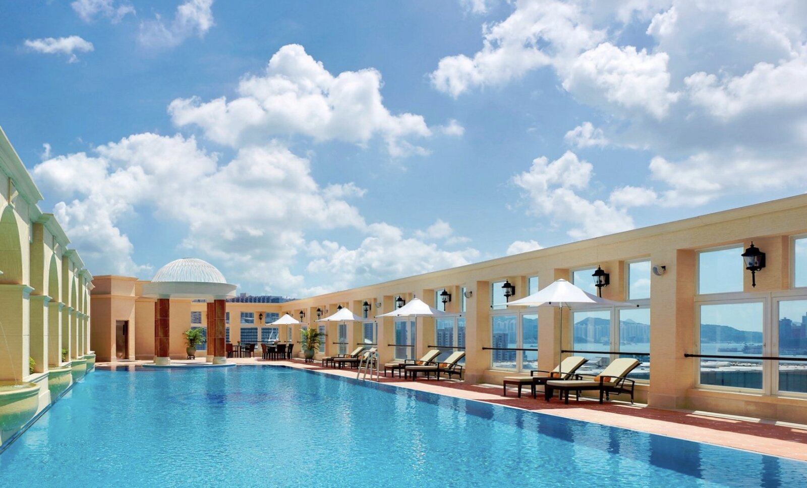 The rooftop pool at The Royal Garden, Hong Kong, with a domed pavilion and harbour views