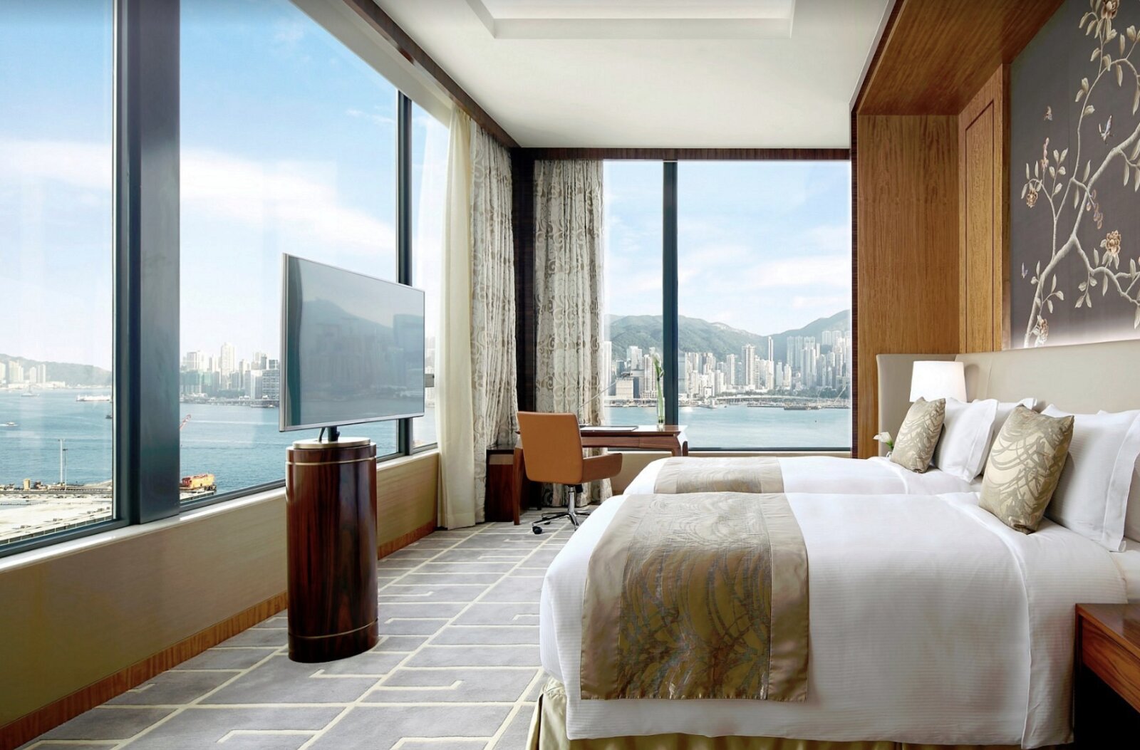 A twin room at The Royal Garden with floor-to-ceiling windows over Victoria Harbour