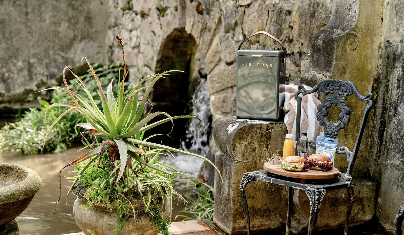 A garden picnic laid out by the water feature